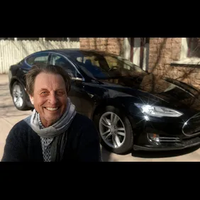 South African Errol  Musk who the father of billionaire entrepreneur Elon Musk. In the background is a Tesla Model S.