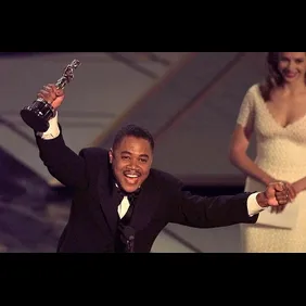 Actor Cuba Gooding, Jr holds up his Oscar after wi