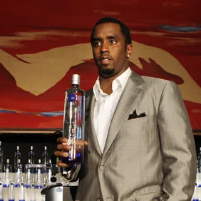 Sean "Diddy" Combs holds a bottle of Cir